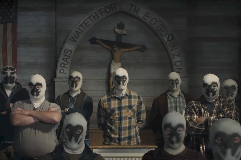 Scene from the Watchmen. A group of white supremacists in black and white masks stand threateningly in a church hall.